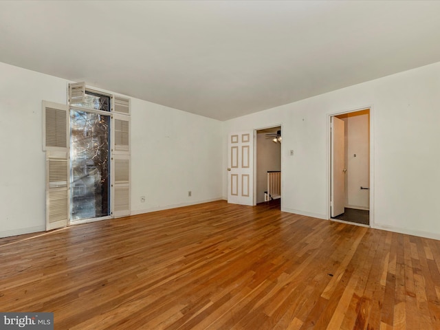 spare room featuring wood-type flooring and ceiling fan