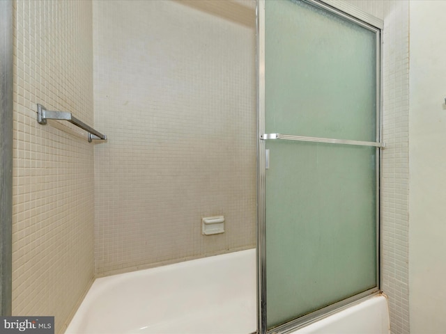 bathroom with shower / bath combination with glass door