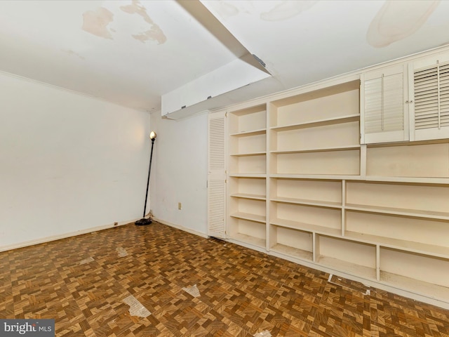 basement with dark parquet floors and built in features