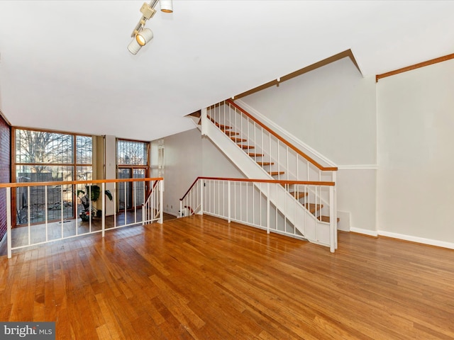 unfurnished living room featuring hardwood / wood-style floors and a wall of windows