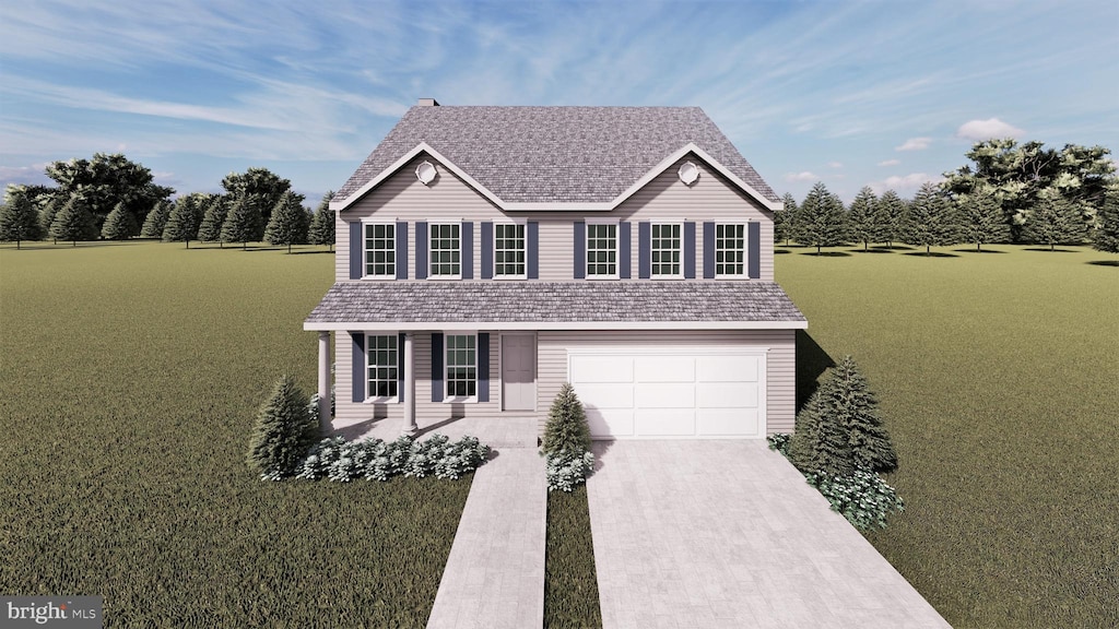 view of front of home with a front yard and a garage