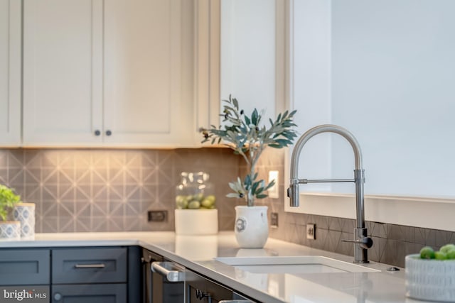 details featuring vanity and tasteful backsplash