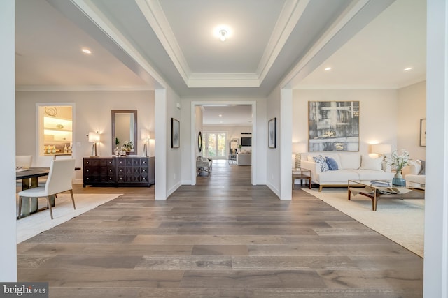 entryway featuring a tray ceiling, dark wood-type flooring, and crown molding