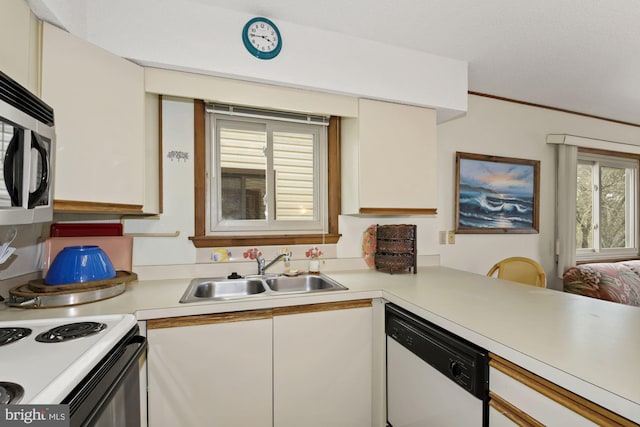 kitchen with kitchen peninsula, white cabinets, white appliances, and sink