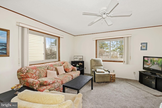 living room featuring light carpet, ceiling fan, and crown molding