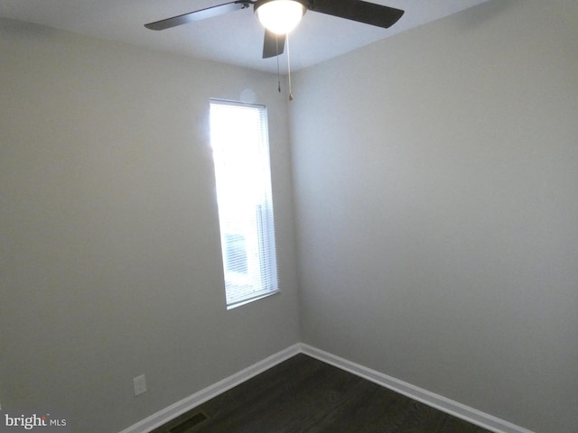 empty room featuring ceiling fan and dark hardwood / wood-style flooring