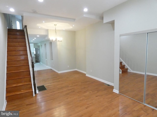 interior space with a notable chandelier and light wood-type flooring