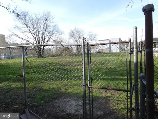 view of gate featuring a yard