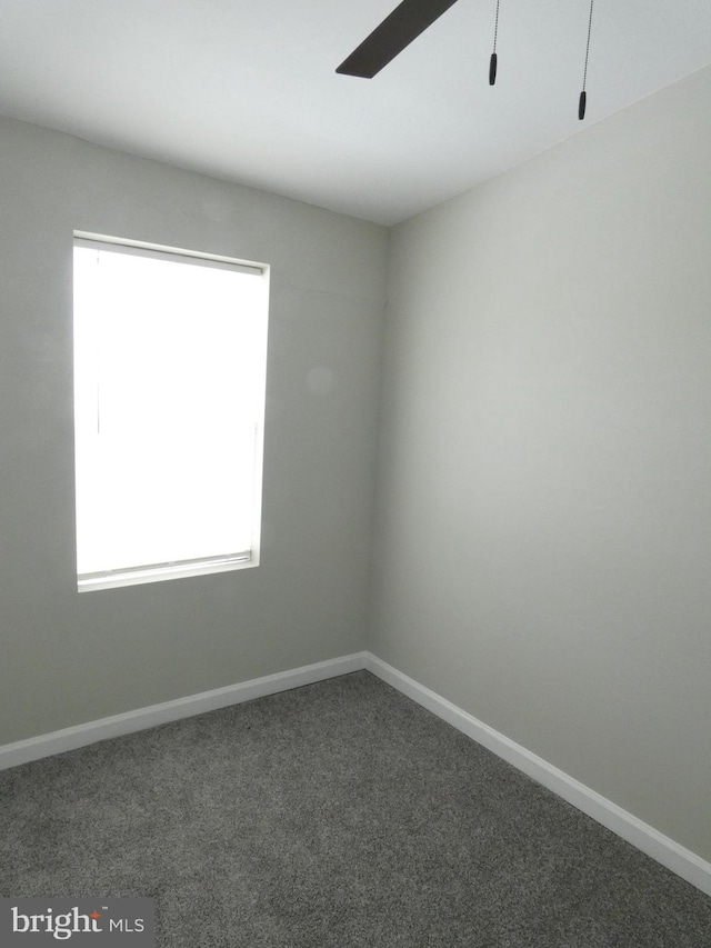 spare room featuring plenty of natural light, carpet, and ceiling fan