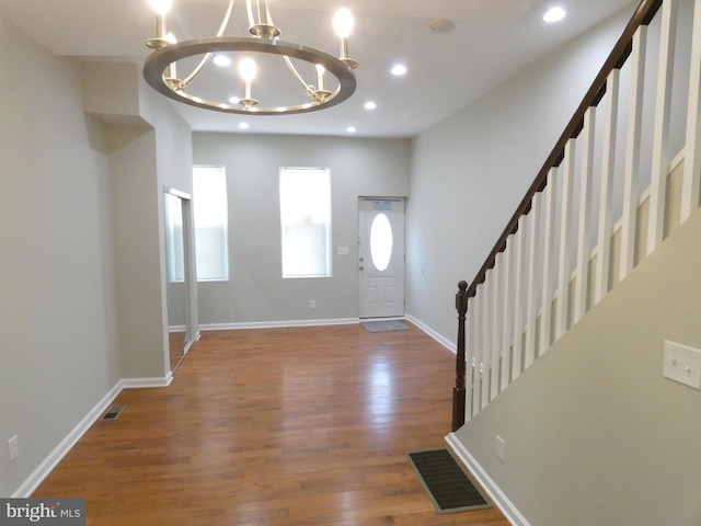 entrance foyer featuring a chandelier and dark hardwood / wood-style floors