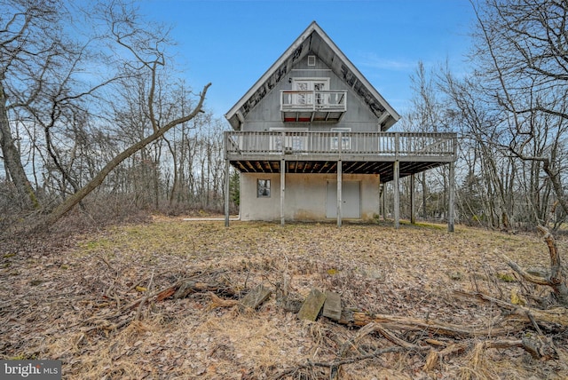 back of house featuring a deck