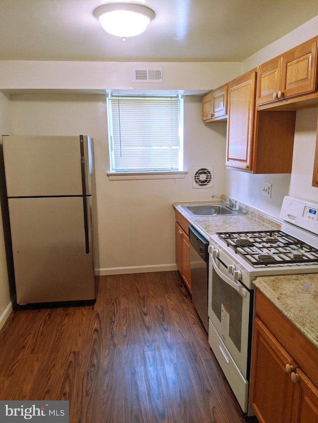 kitchen featuring sink, dark wood-type flooring, and stainless steel appliances