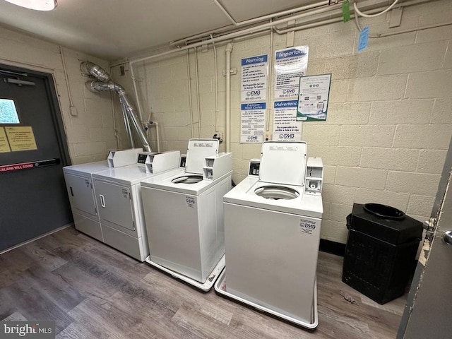 washroom featuring dark wood-type flooring and separate washer and dryer