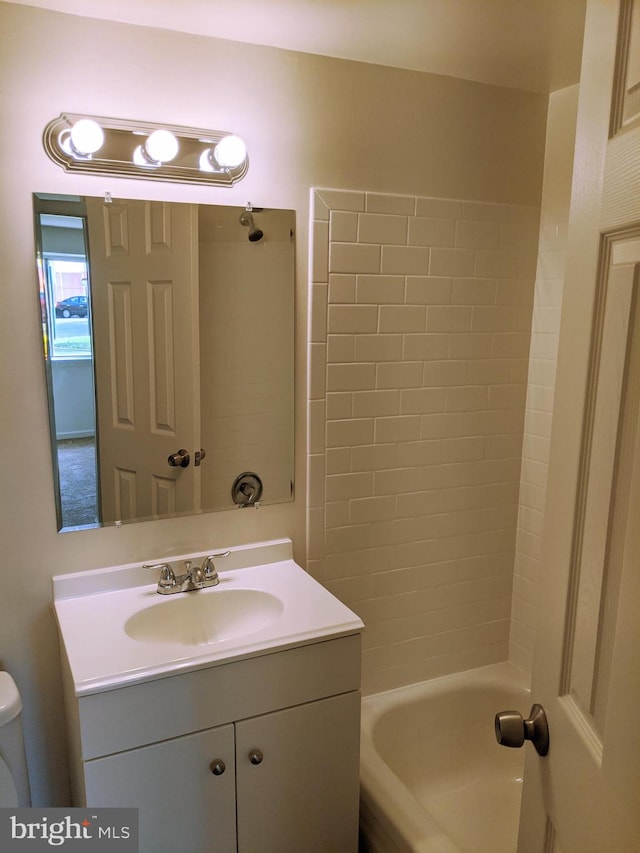 full bathroom featuring vanity, bathing tub / shower combination, and toilet