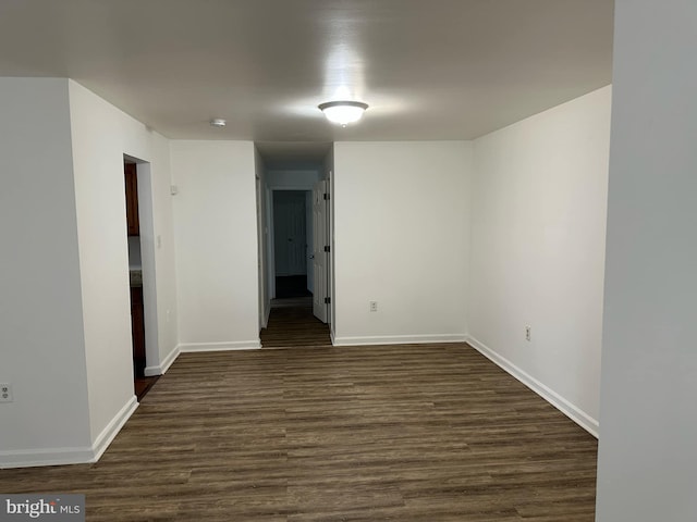 spare room featuring dark wood-type flooring