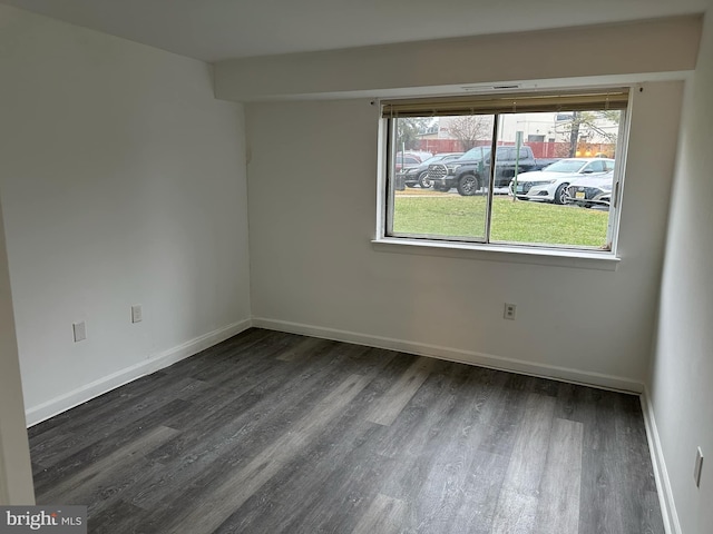 spare room with dark wood-type flooring