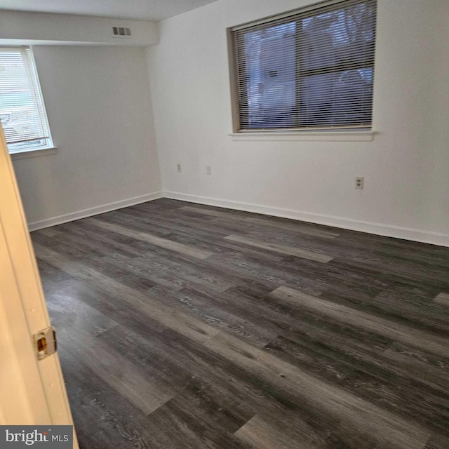 unfurnished room featuring dark hardwood / wood-style flooring