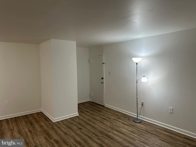 spare room with dark hardwood / wood-style flooring