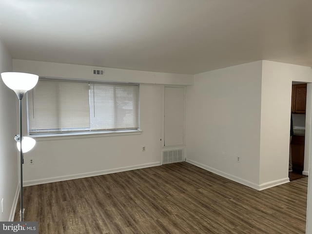 spare room with dark hardwood / wood-style floors