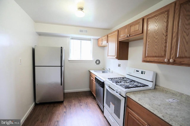 kitchen featuring stainless steel appliances, dark hardwood / wood-style floors, and sink