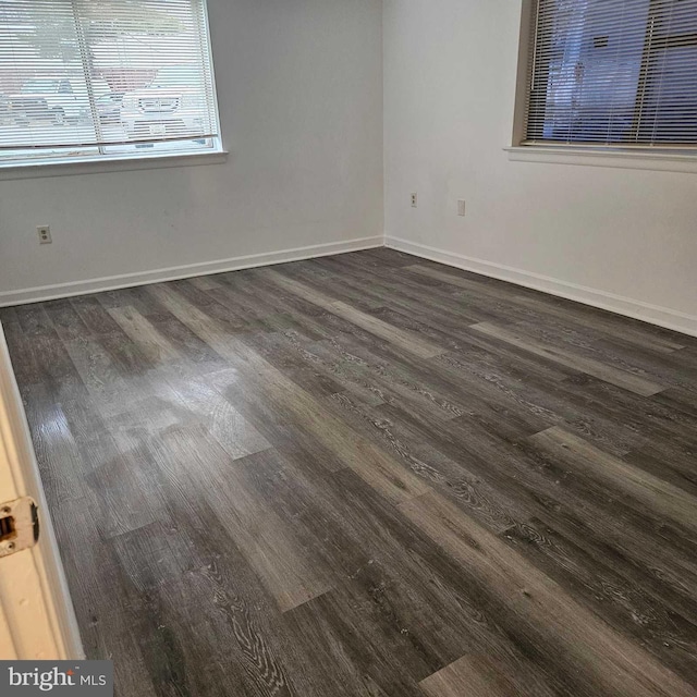 unfurnished room featuring dark wood-type flooring