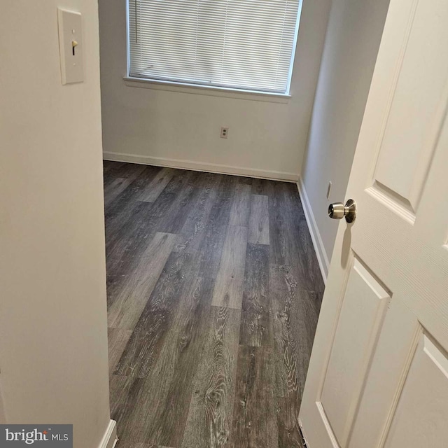 unfurnished room featuring dark hardwood / wood-style flooring and plenty of natural light