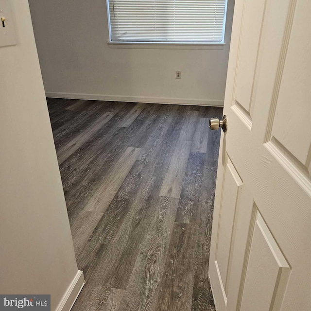 empty room featuring dark hardwood / wood-style flooring