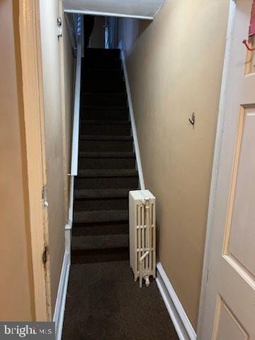 staircase with radiator