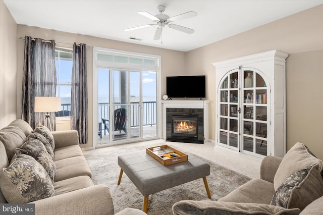 living room featuring light carpet and ceiling fan