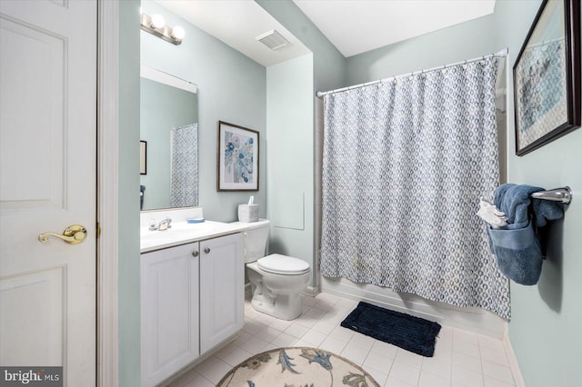 bathroom featuring toilet, tile floors, and vanity with extensive cabinet space