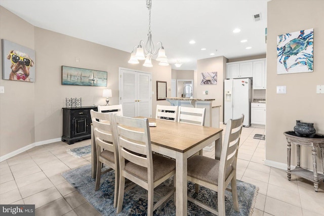 tiled dining space with a notable chandelier