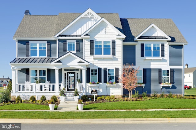 view of front of home with covered porch and a front yard