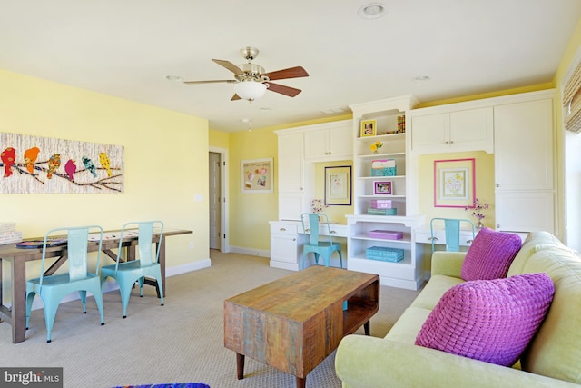 carpeted living room featuring ceiling fan