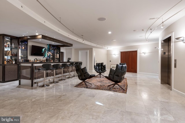 interior space with light tile flooring and elevator