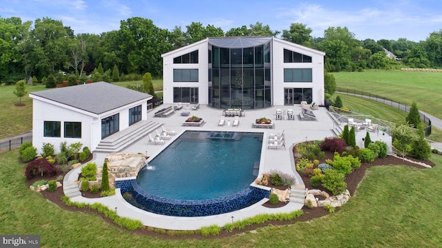 rear view of house featuring a patio area and a yard