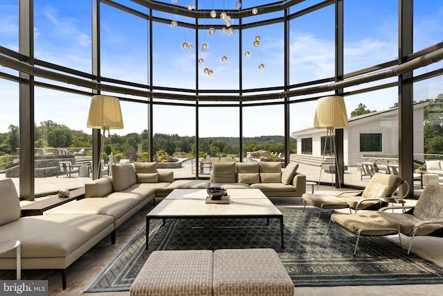 living room featuring a healthy amount of sunlight and floor to ceiling windows