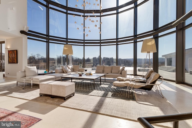 living room featuring a wall of windows and a towering ceiling