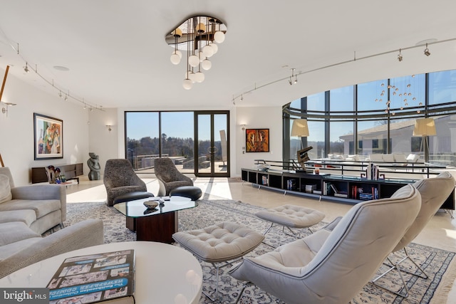 living room with floor to ceiling windows and track lighting