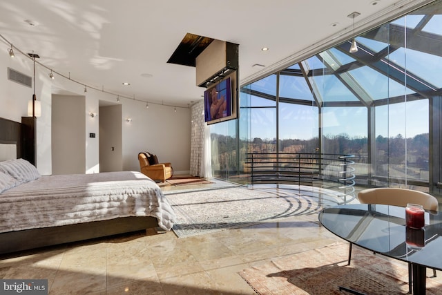 tiled bedroom featuring expansive windows and rail lighting