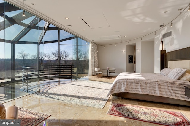 bedroom with track lighting, tile flooring, and expansive windows