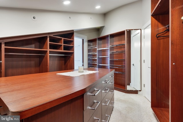 walk in closet featuring light colored carpet and vaulted ceiling