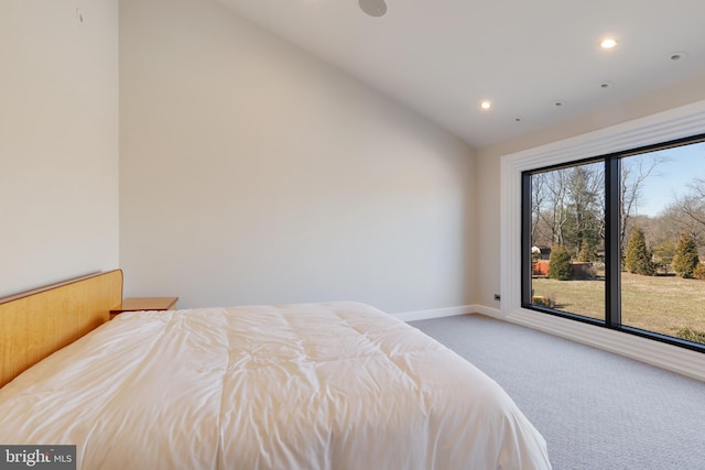 carpeted bedroom with lofted ceiling