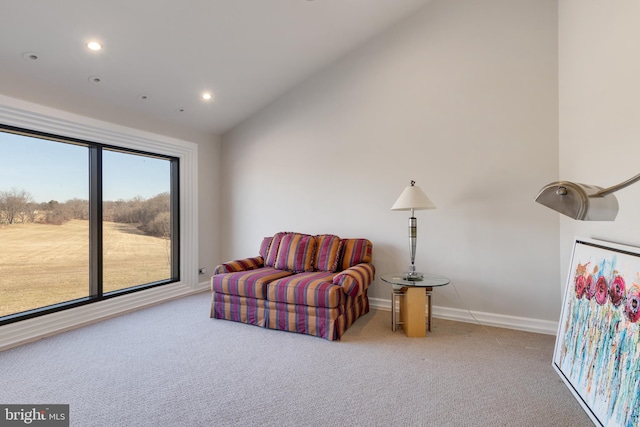 sitting room with lofted ceiling and light carpet