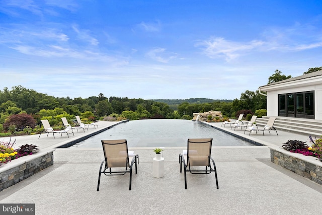 view of swimming pool with a patio