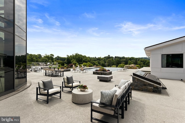 view of patio / terrace with an outdoor living space with a fire pit