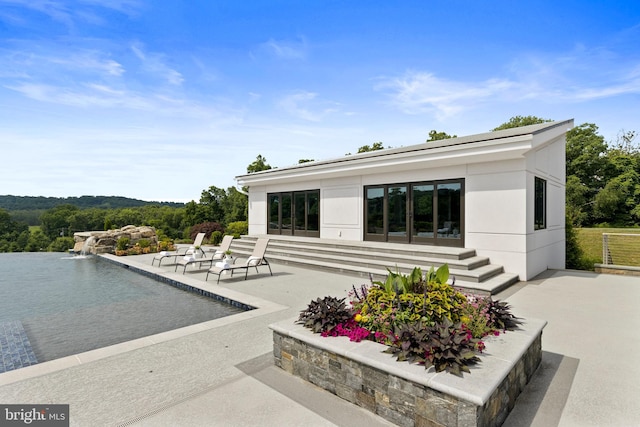 view of patio featuring pool water feature