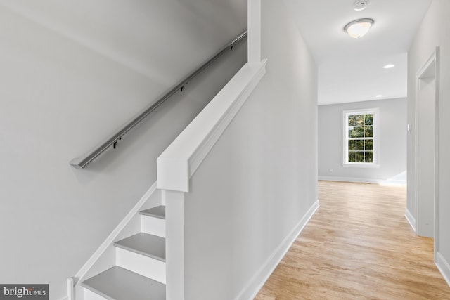 stairs featuring light hardwood / wood-style flooring