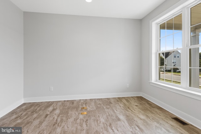 spare room featuring light hardwood / wood-style floors