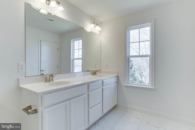 bathroom with vanity and plenty of natural light