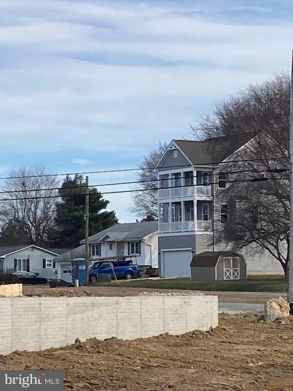 view of front facade featuring a garage and a balcony